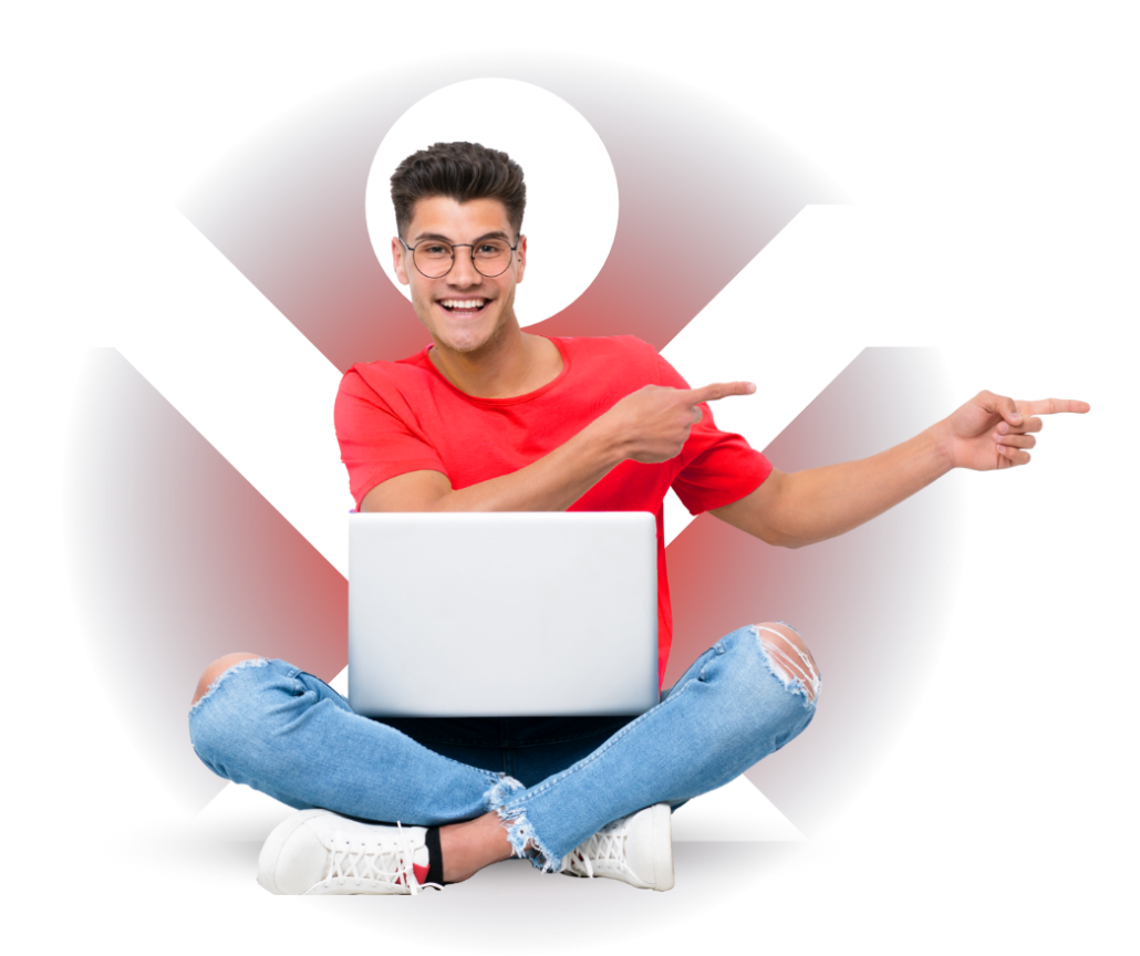 An excited student who is smiling with their laptop on their lap pointing to the right ready to start their online platinum ACCA course. 